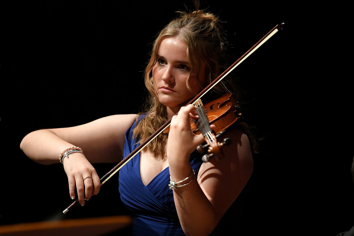 A white female student at Ipswich School playing the violin at Snape Maltings